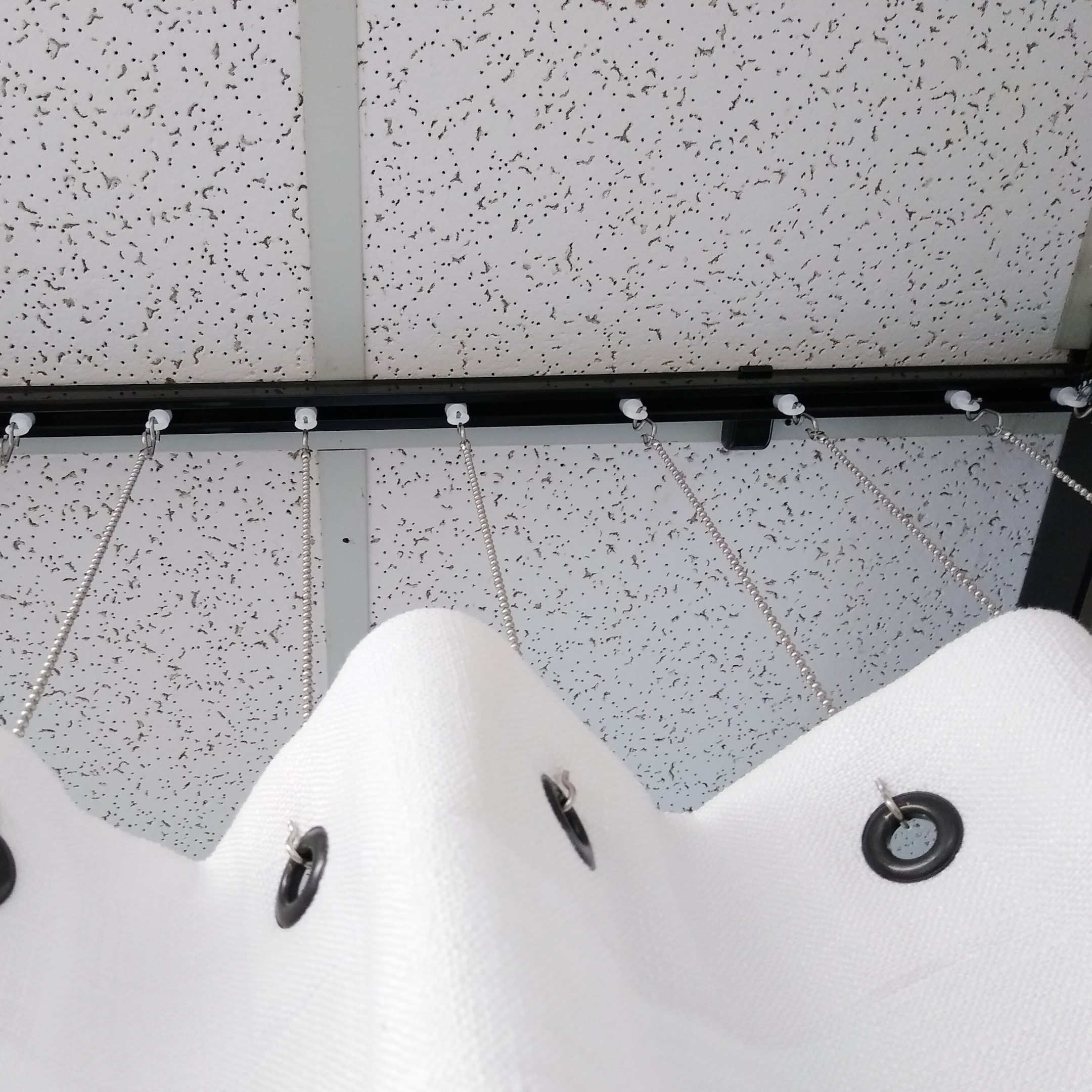 Black CS track on a drop ceiling with drop chains