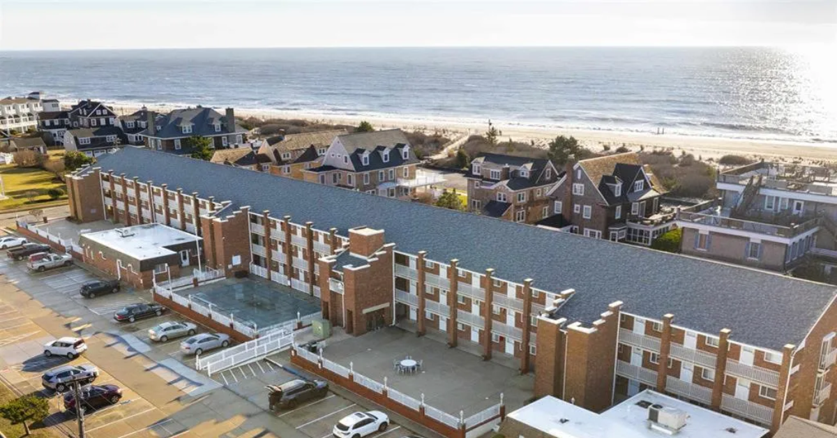 Aerial view of Cape Roc Rentals in Cape May, New Jersey, showing the oceanfront condo complex just steps from the beach.