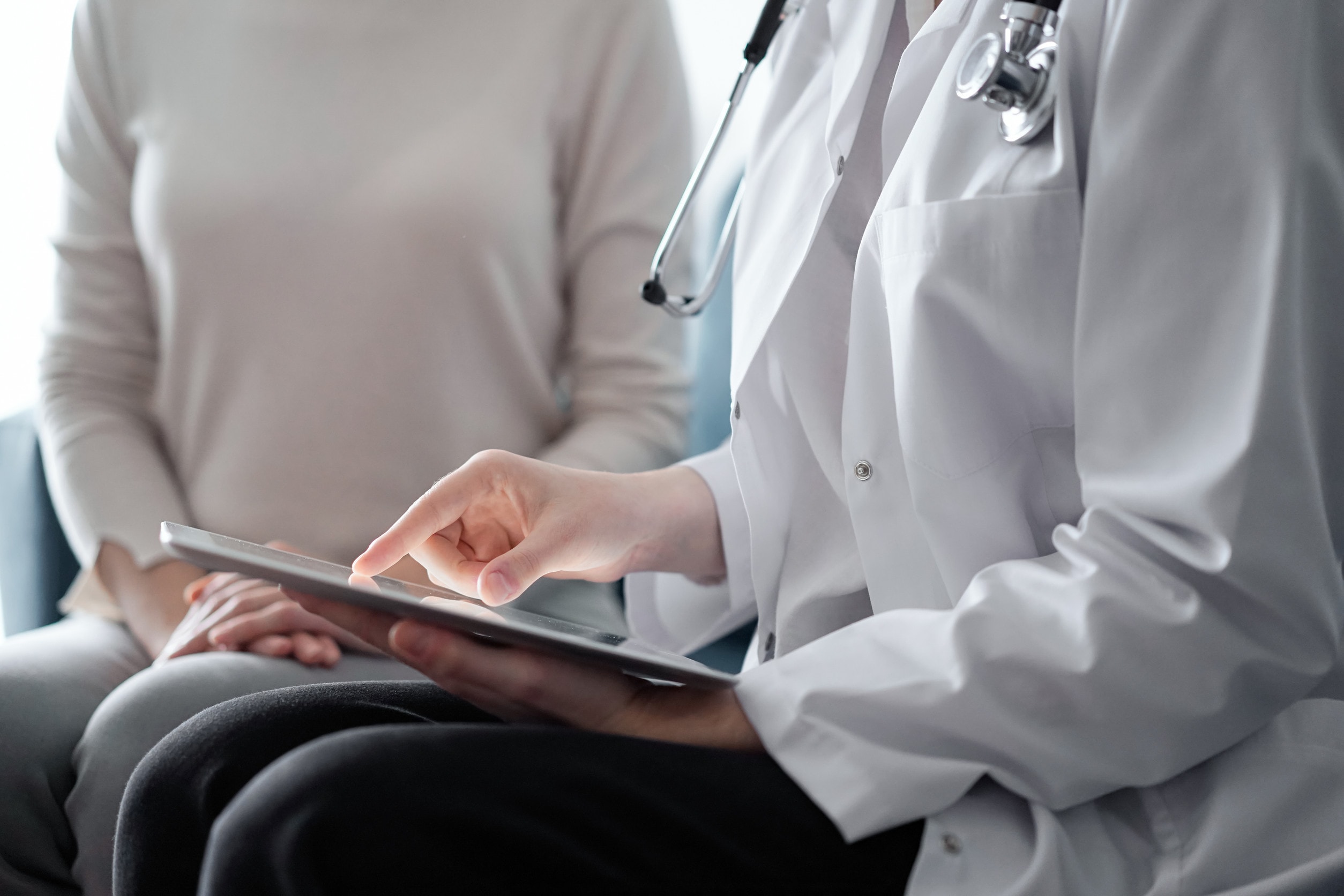 A doctor discusses different types of cosmetic surgery with a patient.