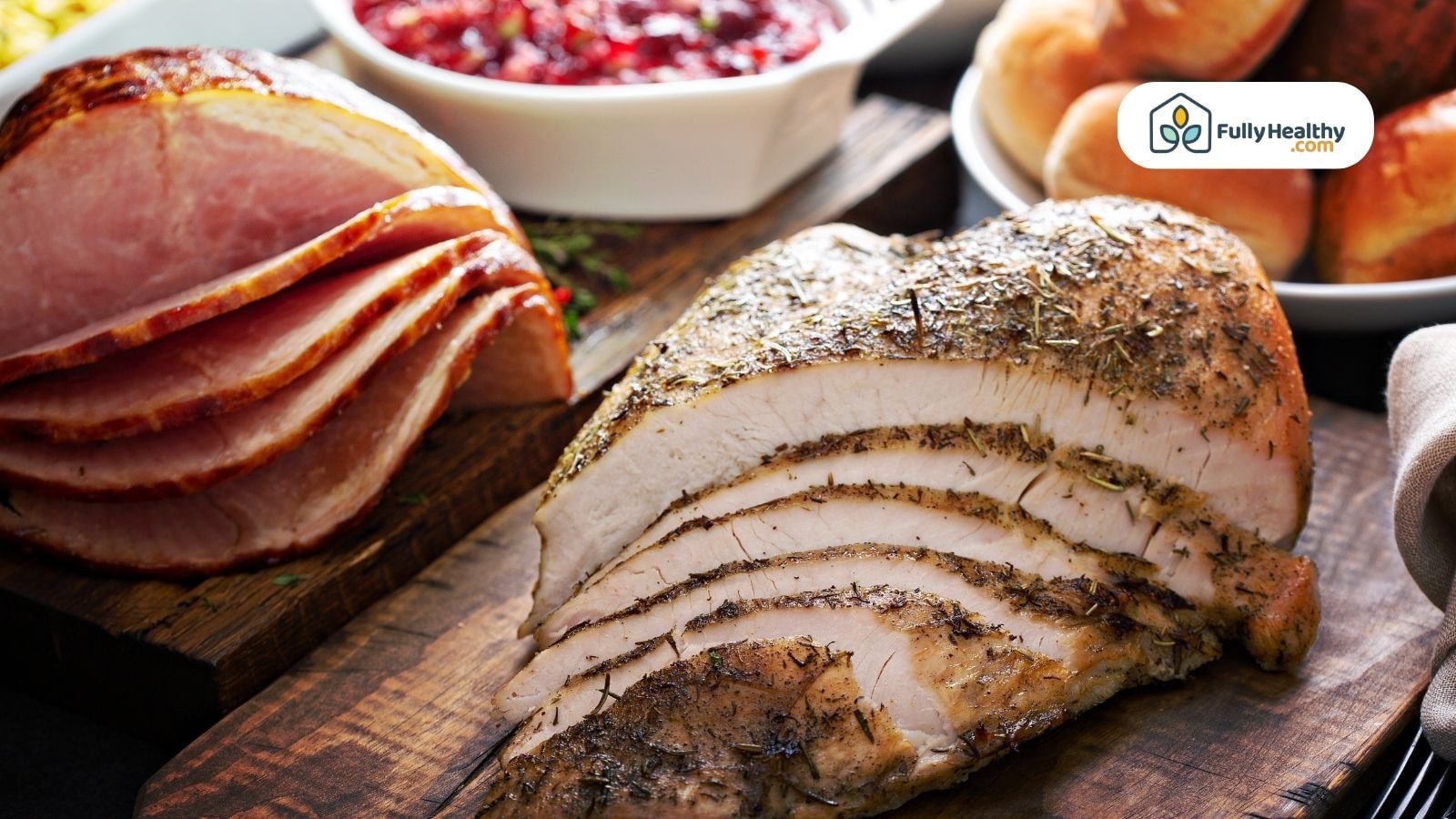 Sliced turkey breast and ham with cranberry sauce and rolls