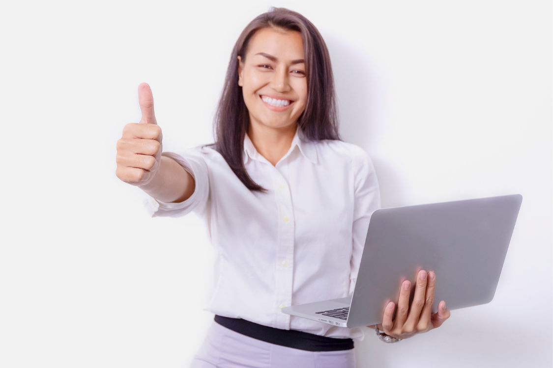 Happy female job applicant holding laptop and giving thumbs up after successful application