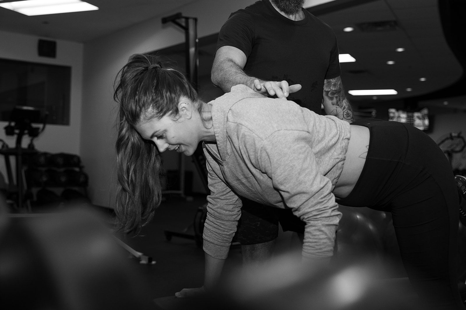 A personal trainer helping a client with a customized workout