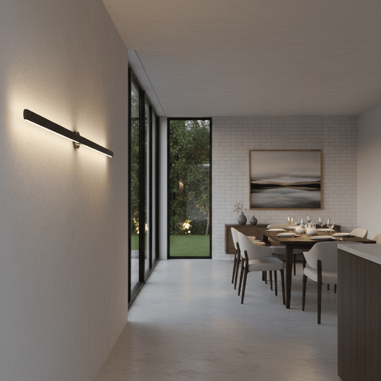 Dining room lit by a slim linear wall light washing soft light along the side wall.