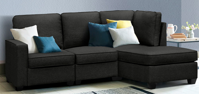 An Artiss 3 seater sofa set decorated with five pillows of varying sizes - two white, two blue and one yellow. 