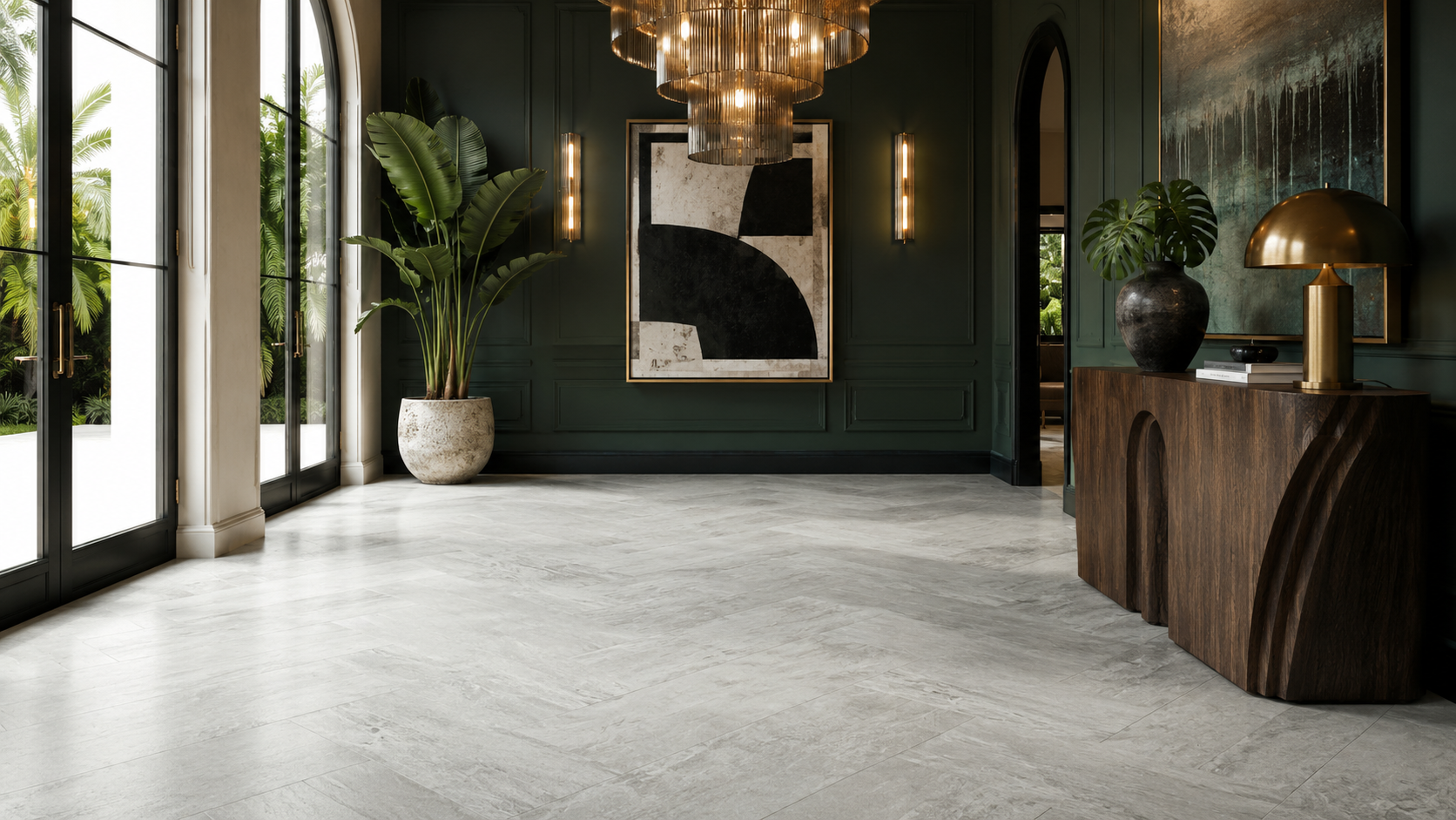 Large-scale herringbone tile floor in a luxury entryway with green walls and brass lighting.