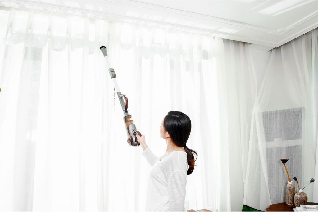 Vacuum your curtains using a dust brush attachment