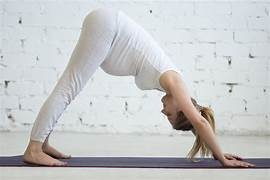A pregnant woman in cobra and upward dog poses