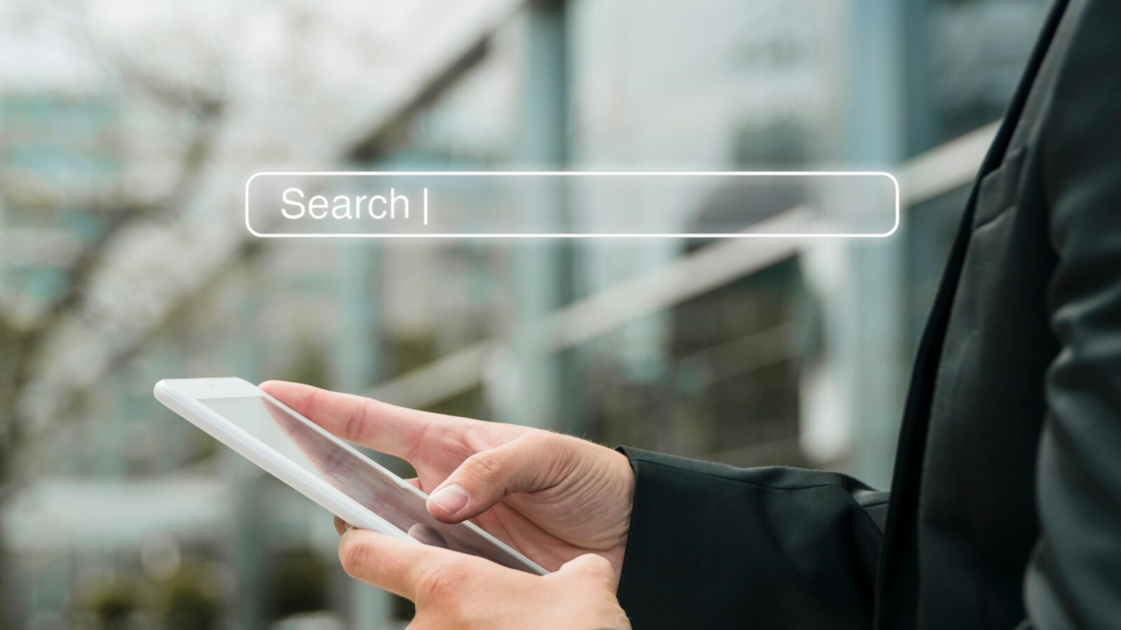 Hands using a tablet with search bar overlay, representing smart keyword planning for search engine optimization (SEO)..