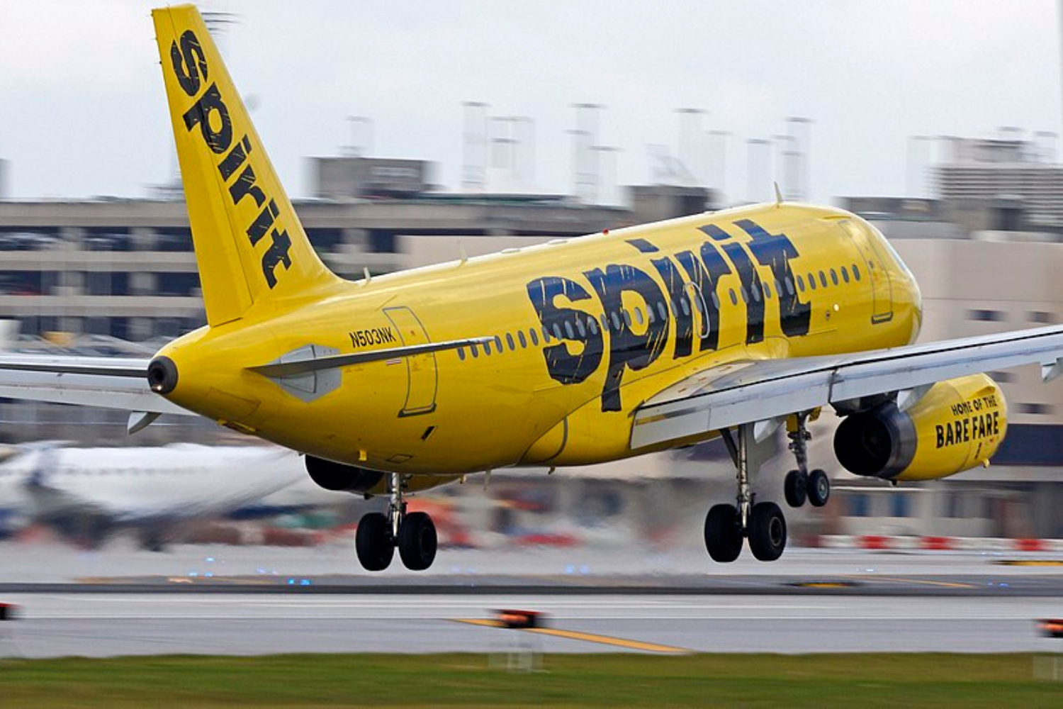 a yellow spirit flight preparing for take off