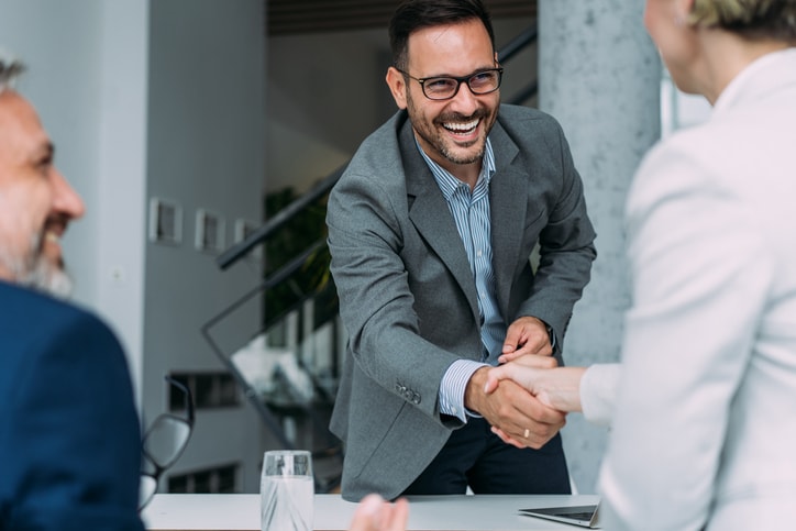 Accountant shakes hands with client after spending review