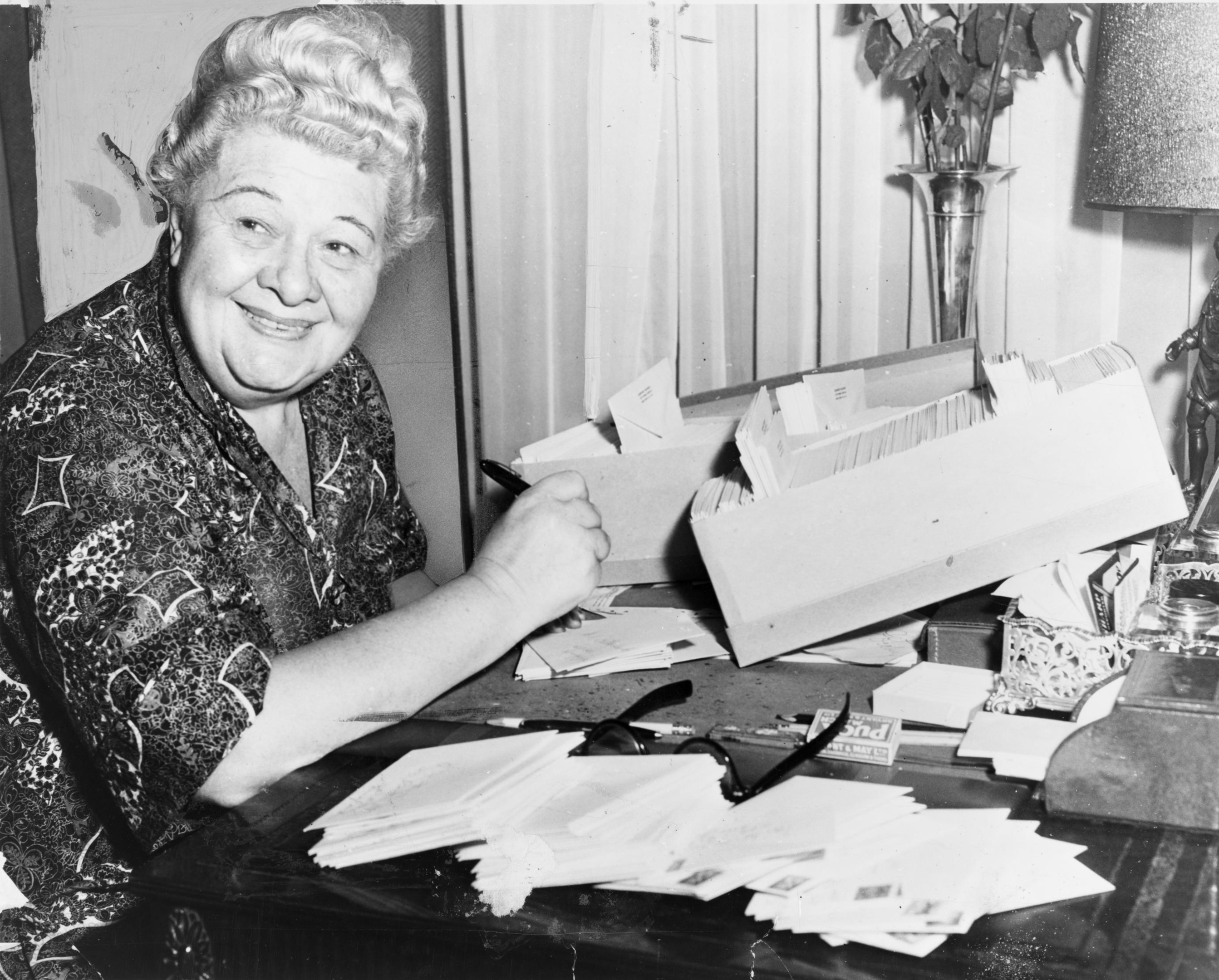 Absolutely captivating funny woman Sophie Tucker sits at her desk, writing jokes for her live comedy show.