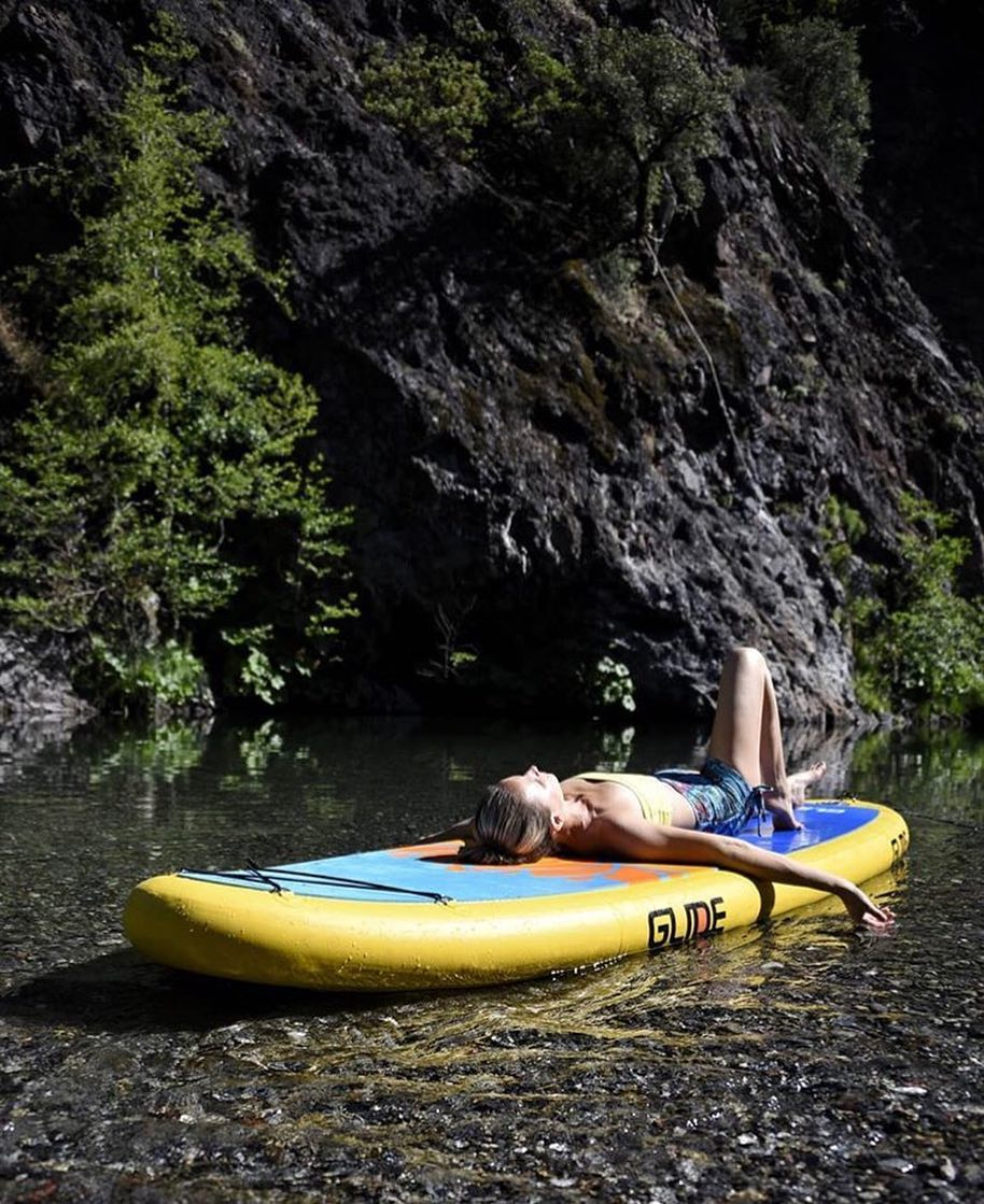 woman lying on an inflatable paddleboard