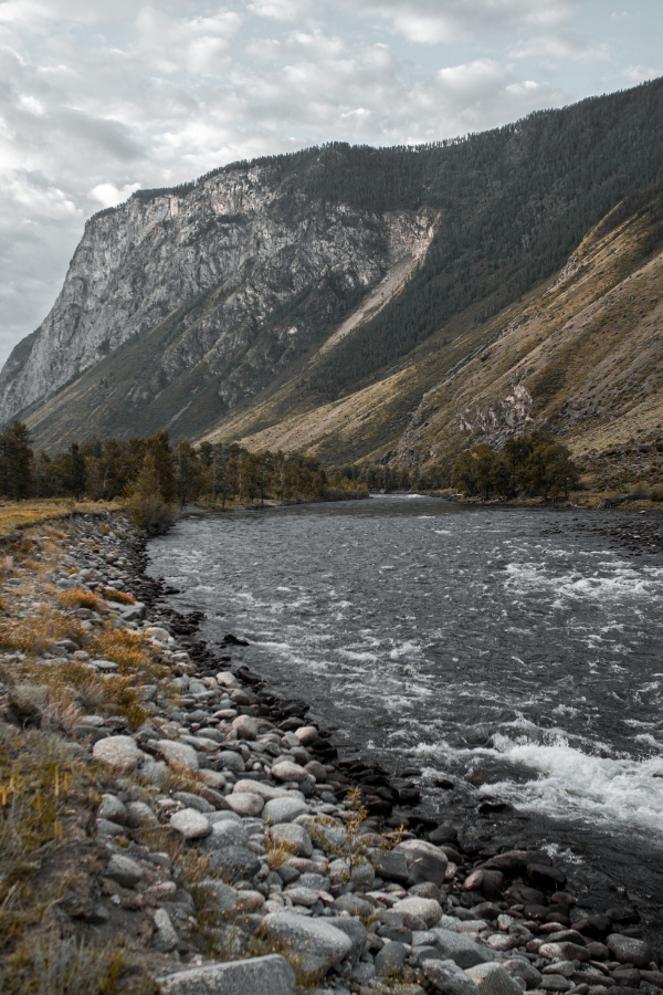 a beautiful mountain and river during winter