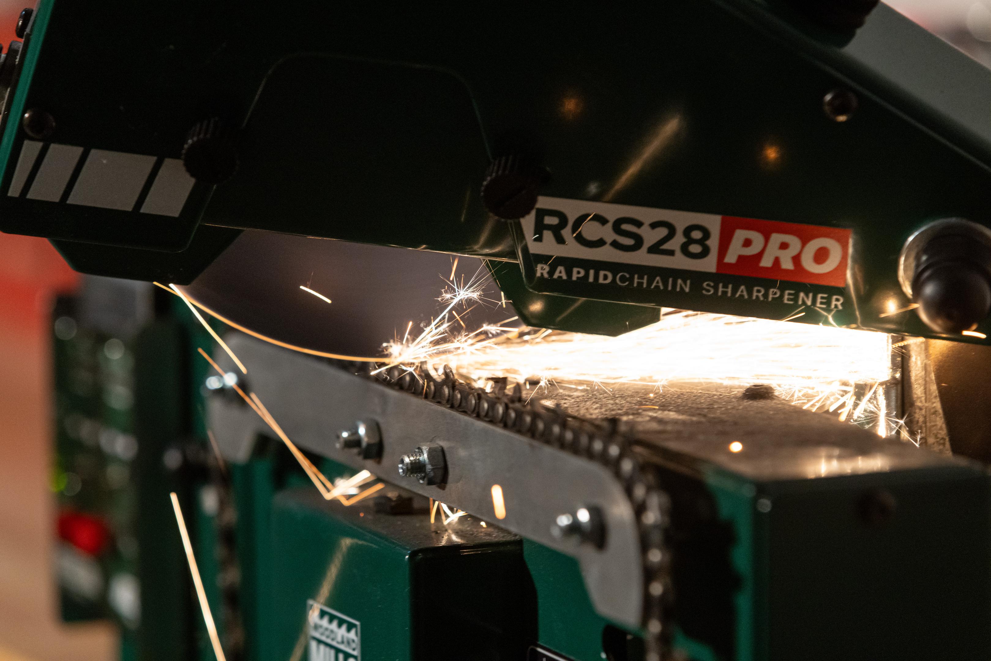 A chain saw chain being sharpened on an RCS28 PRO Chainsaw Sharpener. 