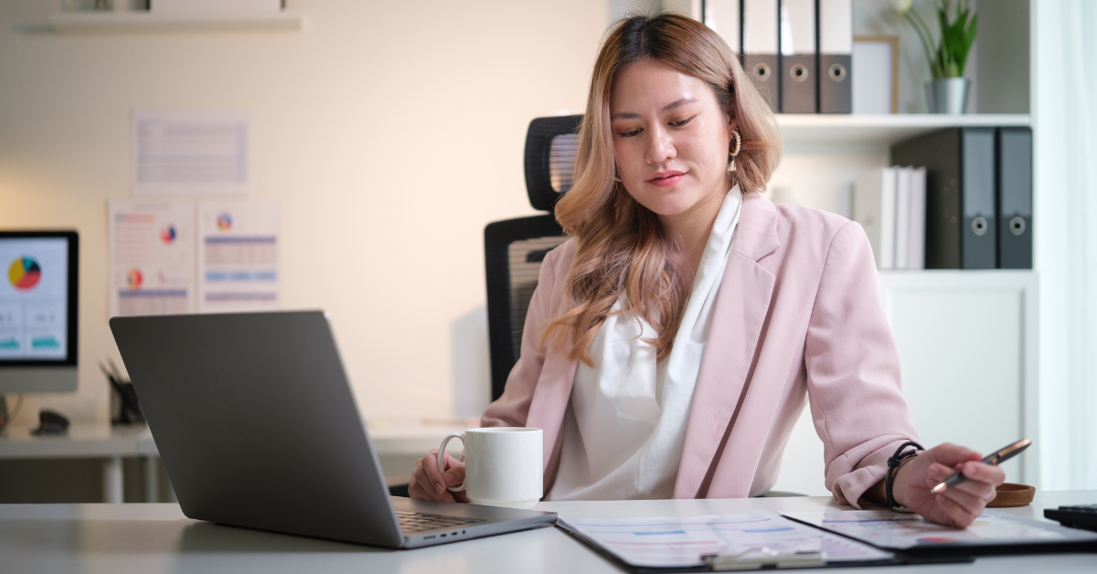 Woman reviewing her aged payables report to stay compliant with taxes.