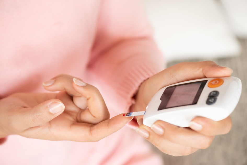 Image of a glucometer displaying a normal blood sugar reading, alongside an insulin pen.