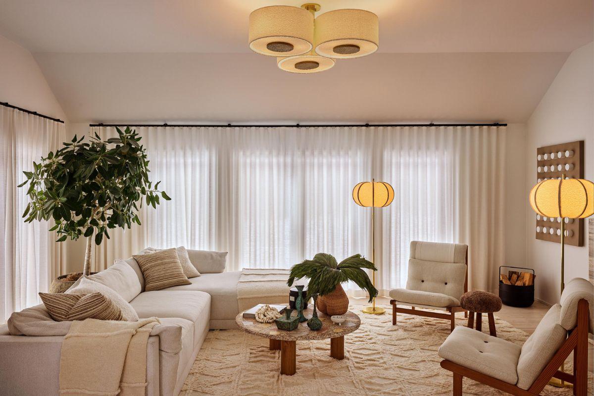 Three-light semi flush mount ceiling fixture illuminating a warm modern living room