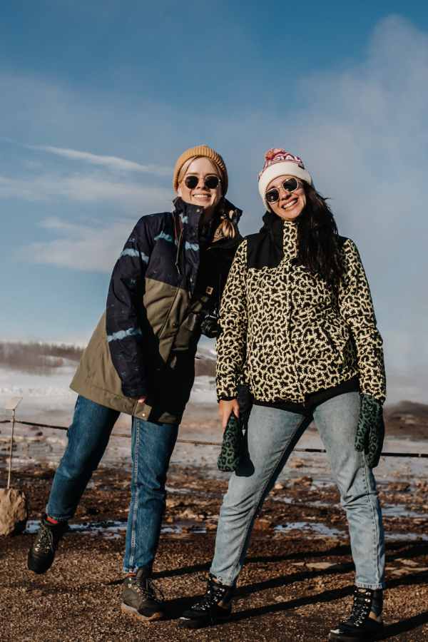 two friends wearing coats outdoors during winter