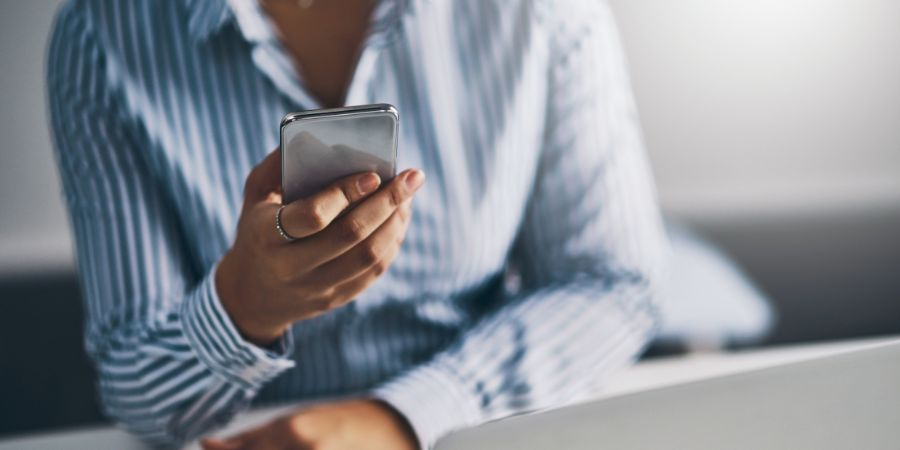 Businesswoman looking at a notification on her mobile phone