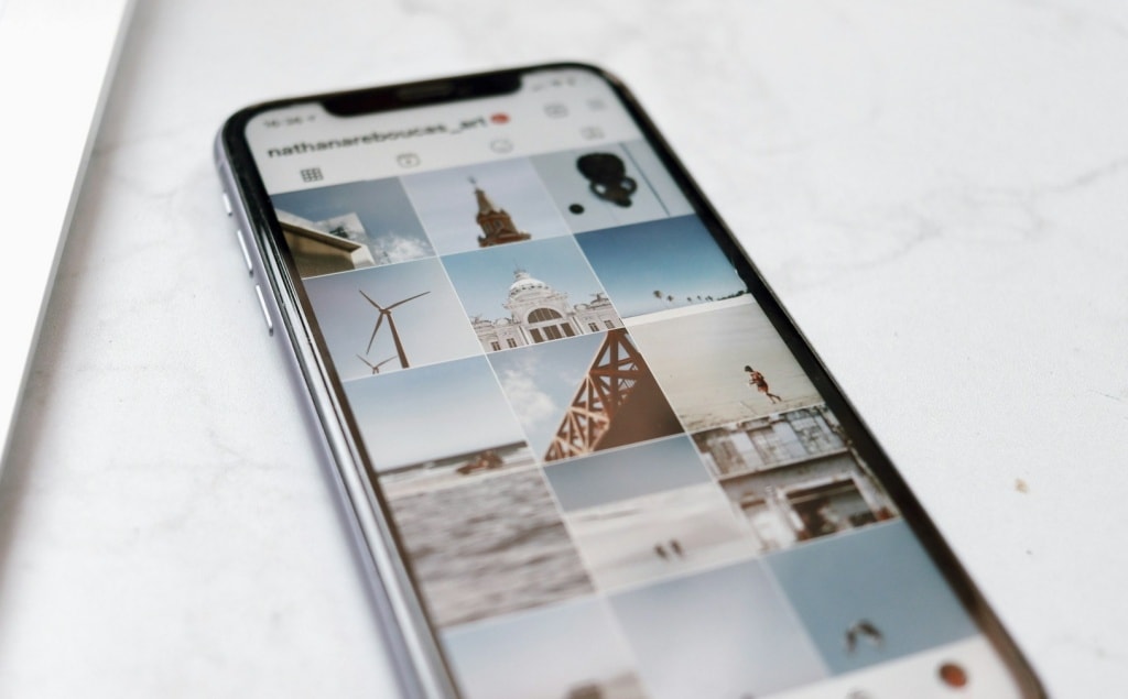 A person's Instagram profile with photos of wind turbines, ocean scenes, and architecture