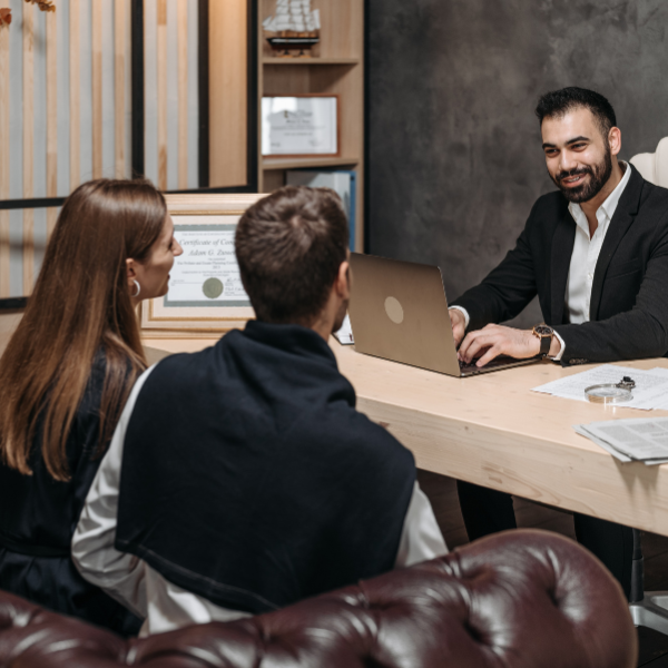 An image of a lawyer explaining fee structures to a client in Alabama.