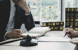 A no win no fee food poisoning compensation claims solicitor talks to a client