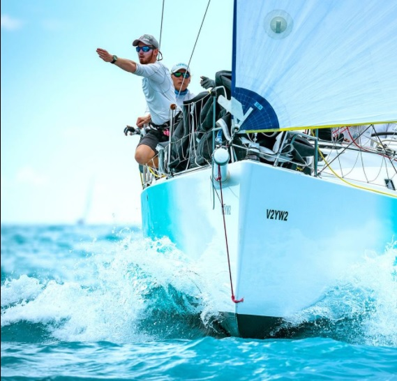 two men on a sailing boat giving directions