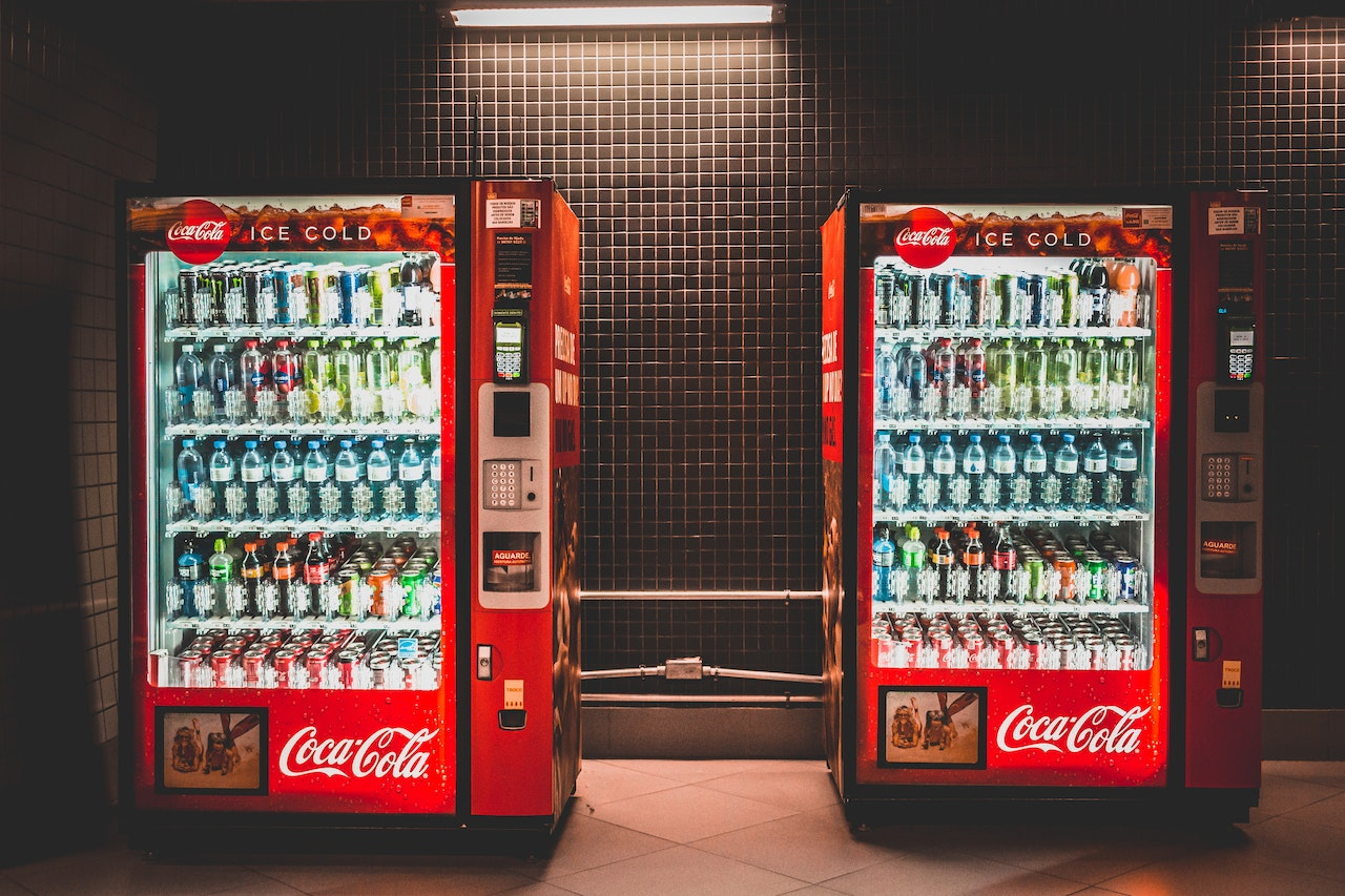 Two Coca Cola drinks vending machines side by side