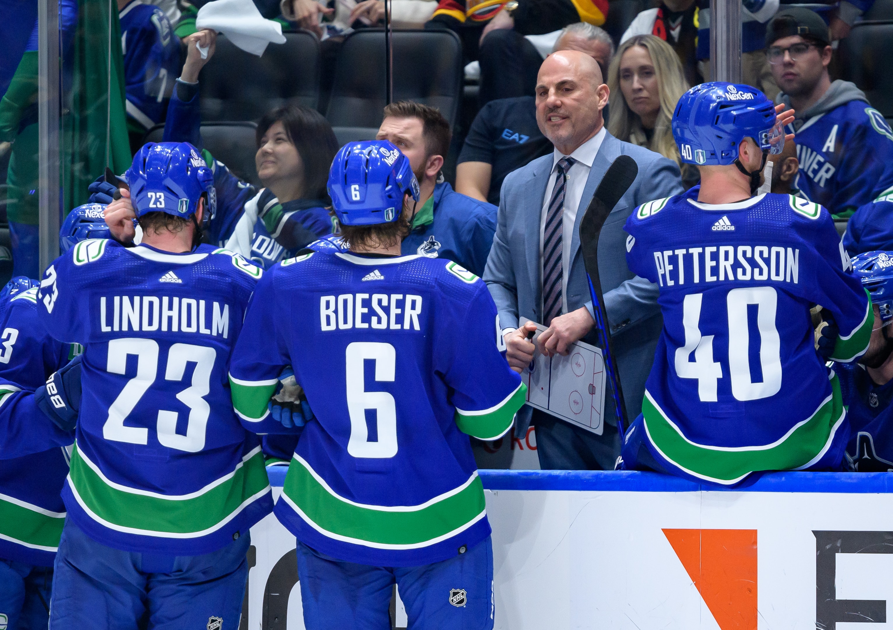 Vancouver Canucks head coach Rick Tocchet talks to Brock Boeser and Elias Lindholm during Game Five of the First Round of the 2024 Stanley Cup Playoffs at Rogers Arena on April 30, 2024 in Vancouver, British Columbia, Canada.