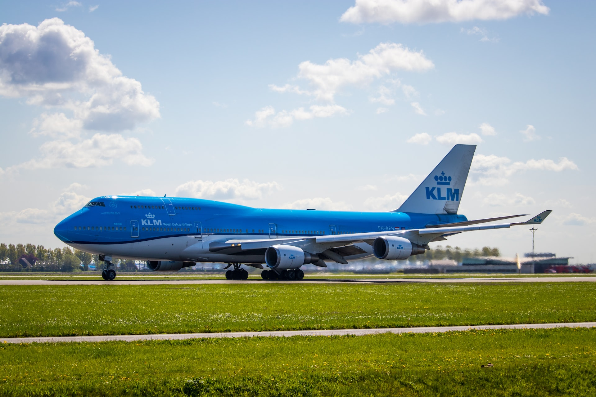 A KLM's triple decker plane Boeing 747 taxiing on the runway.