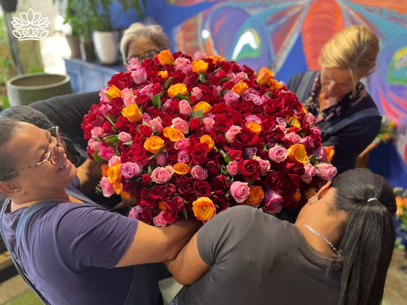 Florists preparing a big bouquet of colorful roses, the perfect gift for Mother's Day, from the Flower Bouquets Collection at Fabulous Flowers and Gifts, delivered with heart and soul.