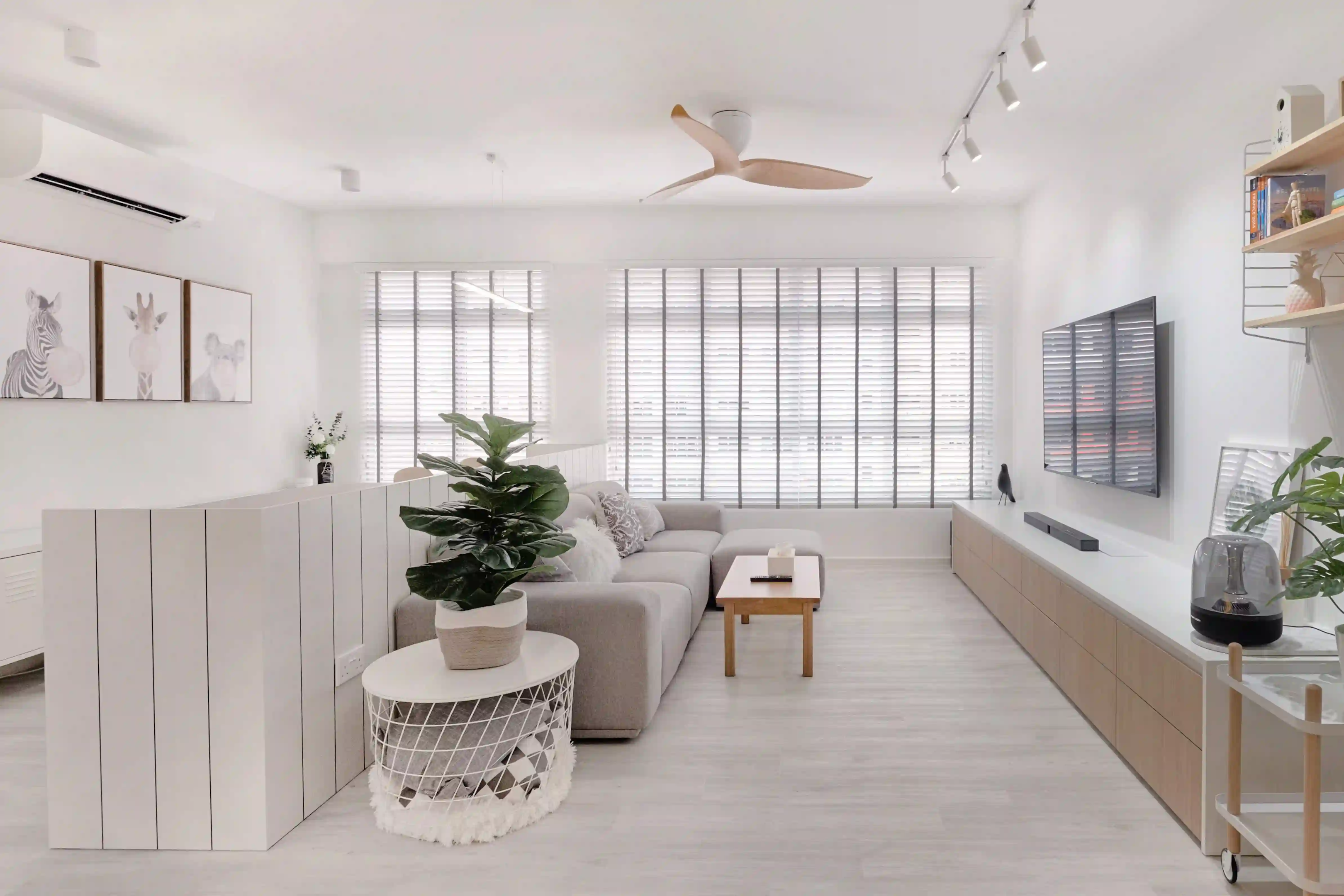 Minimalist house living room with white walls, long TV console and soft daylight