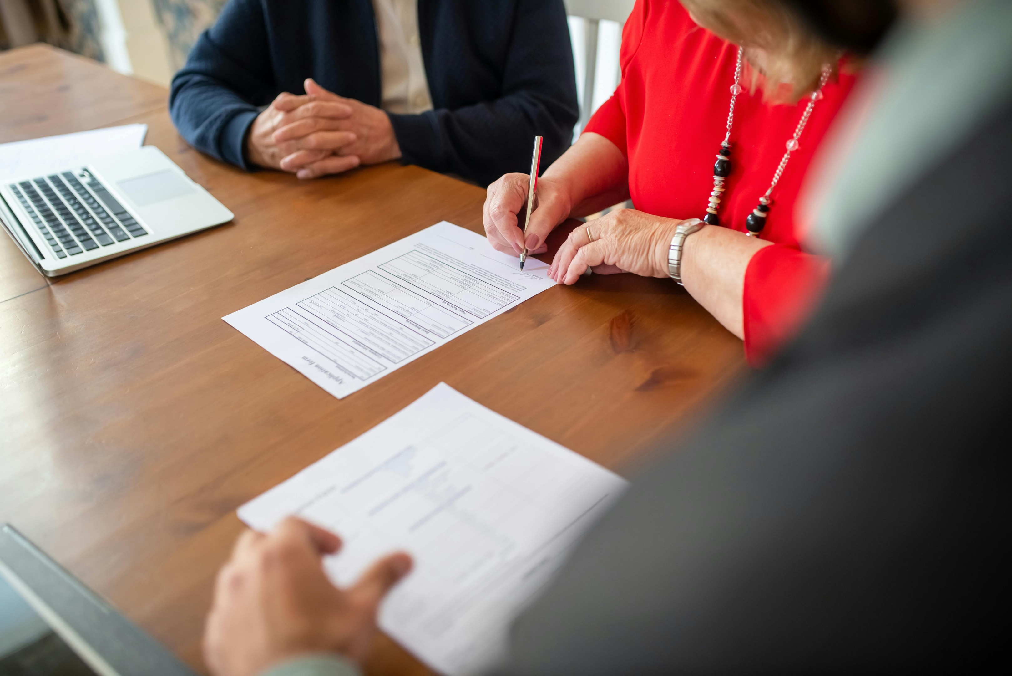 woman signing contract in office