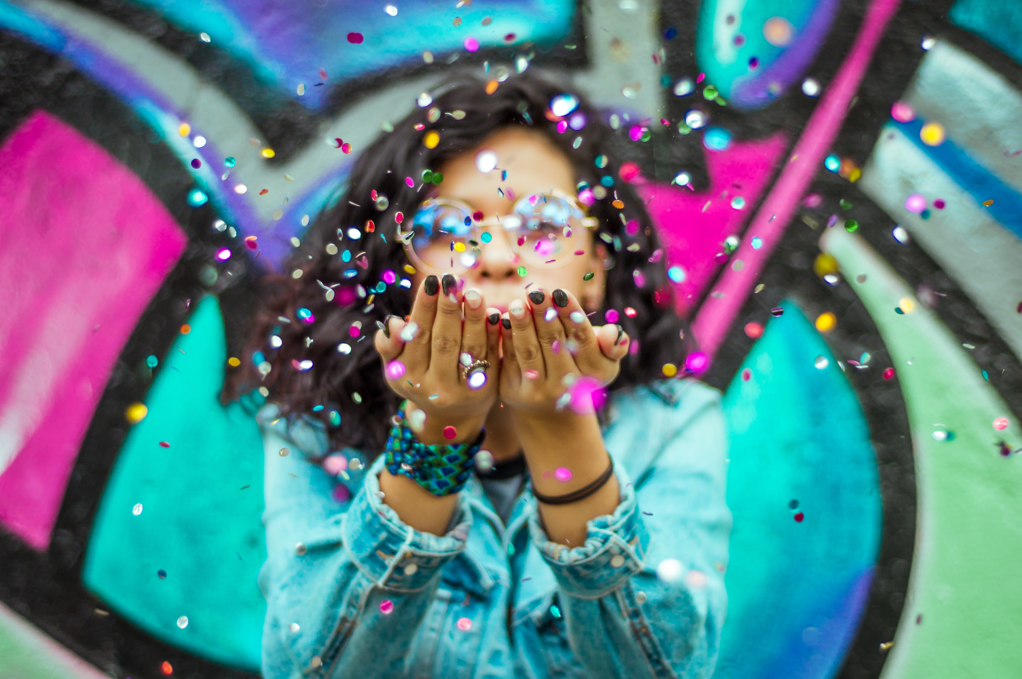 girl blowing confetti