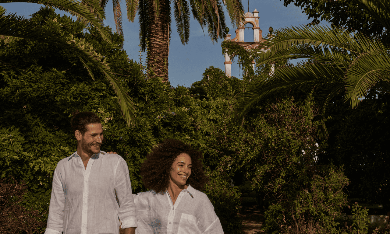 Couple in a forest looking laughing and having a great time.