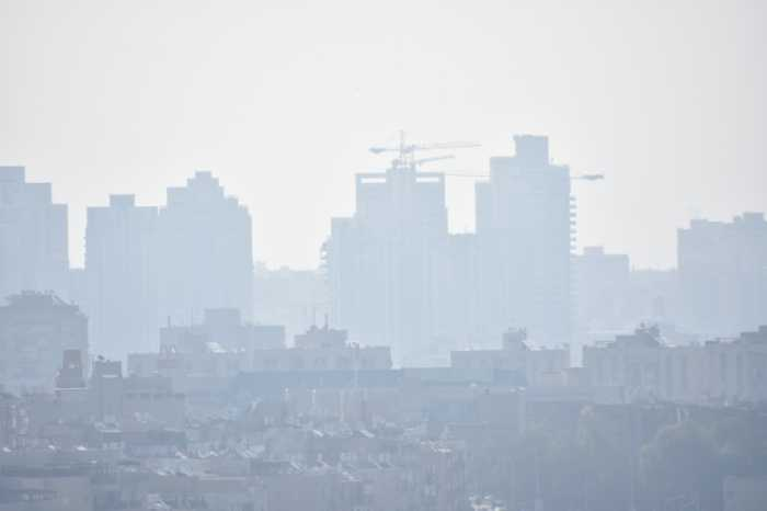 How to prepare for climate change: monitor air quality. Image of a city plagued by smog