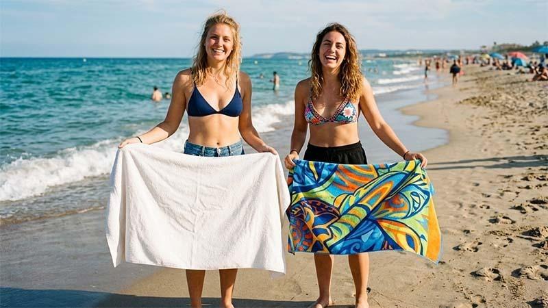 Two women holding cotton and microfiber towels