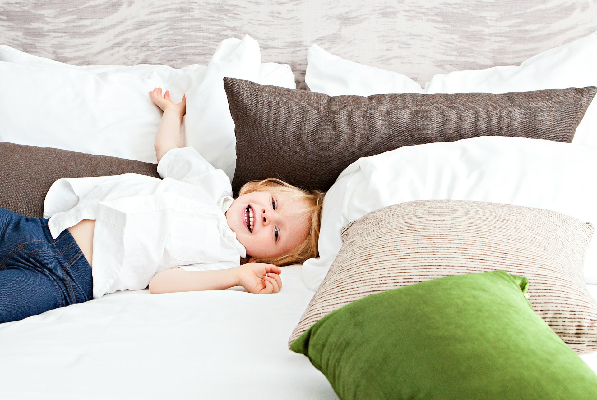 a young child playing on a bed