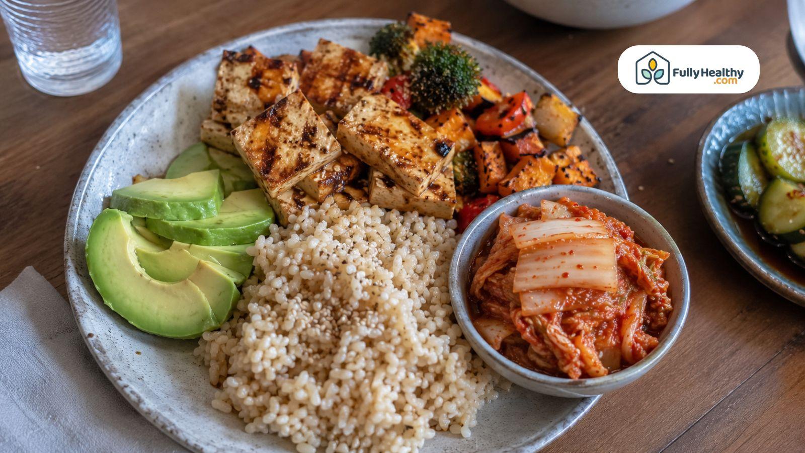 Vegan kimchi served with tofu, brown rice, avocado, and roasted vegetables.
