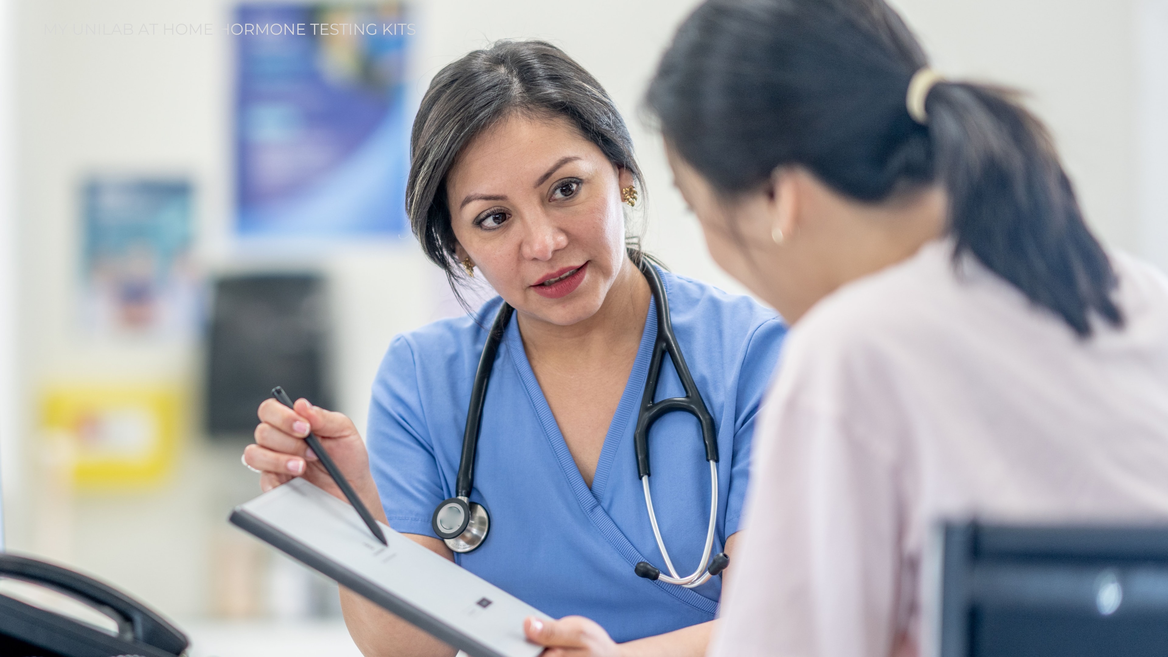 A female doctor explaining a chart to her female patient.