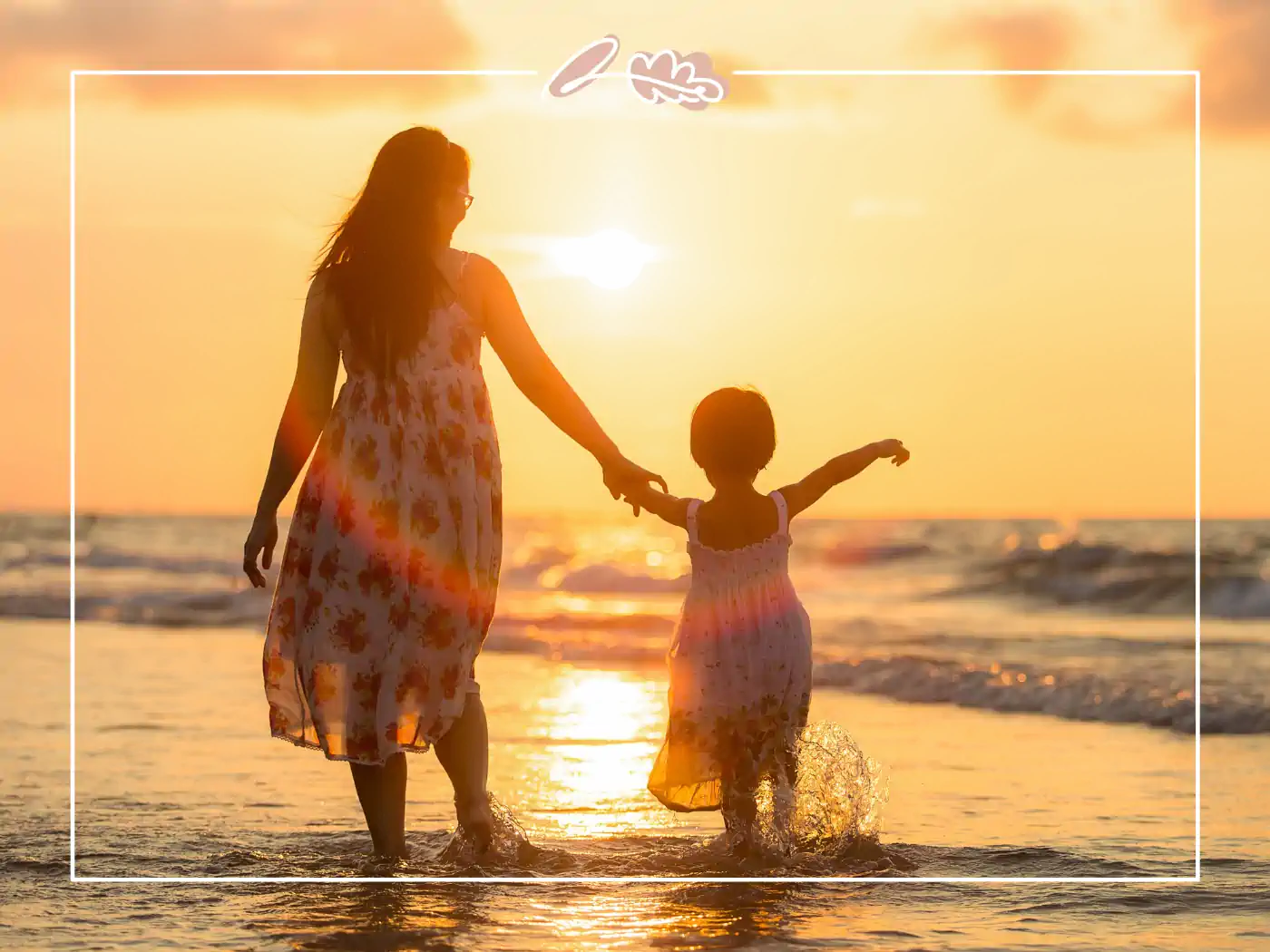 A mother and daughter holding hands while walking along the beach during sunset. Fabulous Flowers and Gifts.