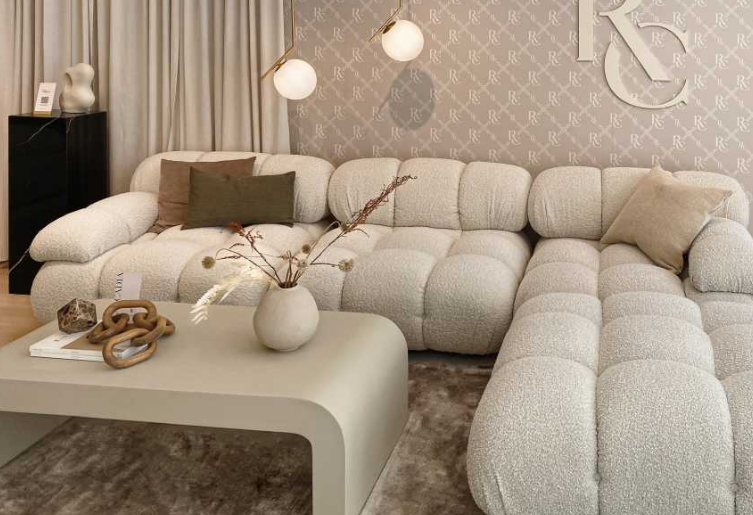 beige single tier waterfall coffee table and tan sofa