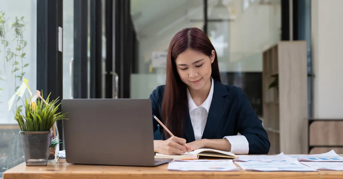 A woman reviewing a breakdown of profits to understand the OnlyFans percentage cut.