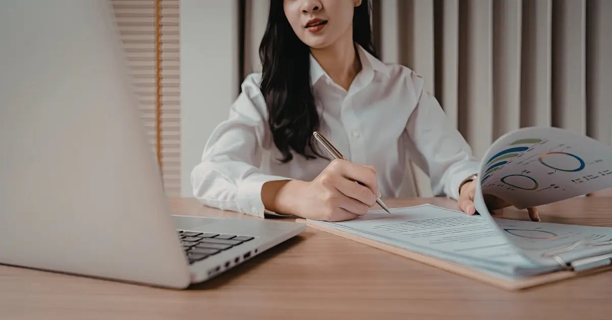 Woman reviewing paperwork for an adult business tax guide.