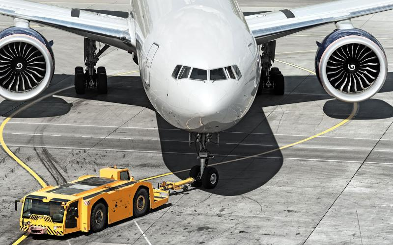 An aircraft being towed to the runway; pushing back airplane