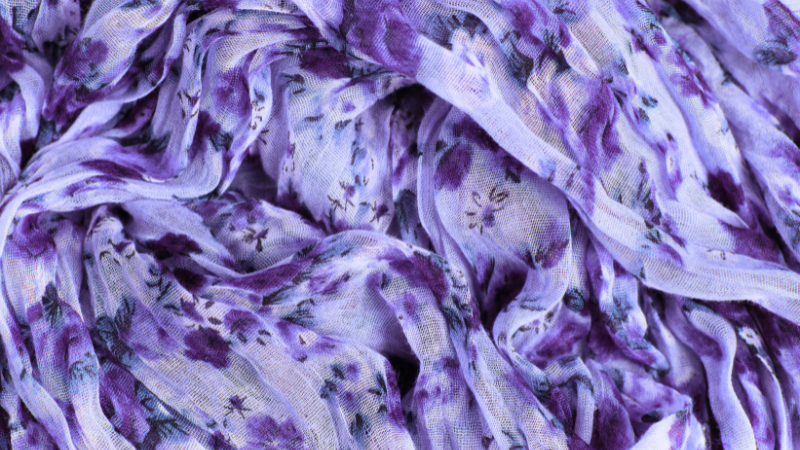 A close up of a purple and white floral modal fabric