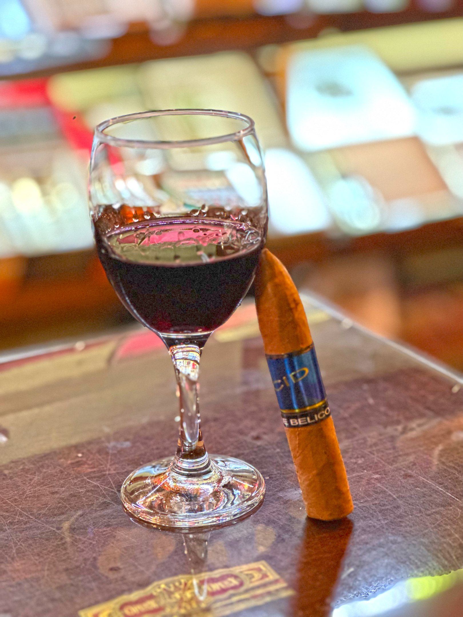 Enjoying a glass of wine with an ACID Blondie Belicoso cigar