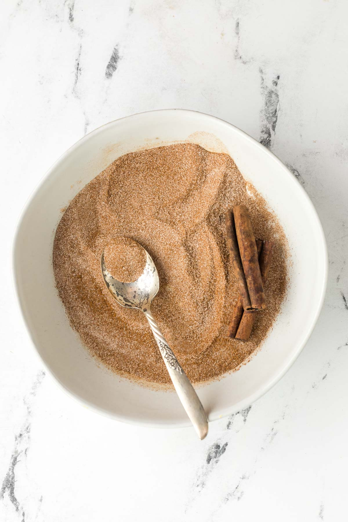 bowl of homemade cinnamon sugar with a spoon in the bowl