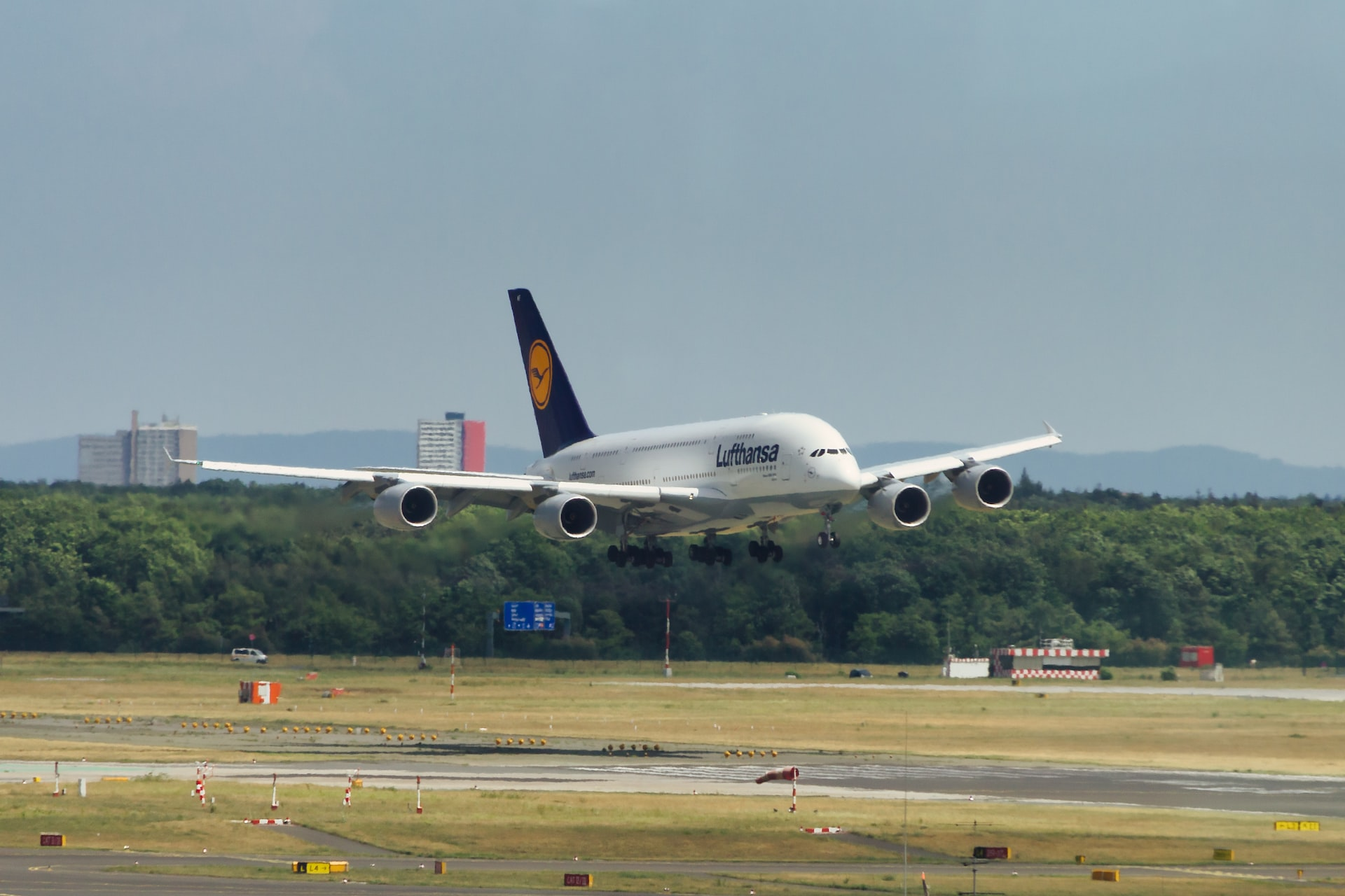 A Lufthansa aircraft landing on a runway.