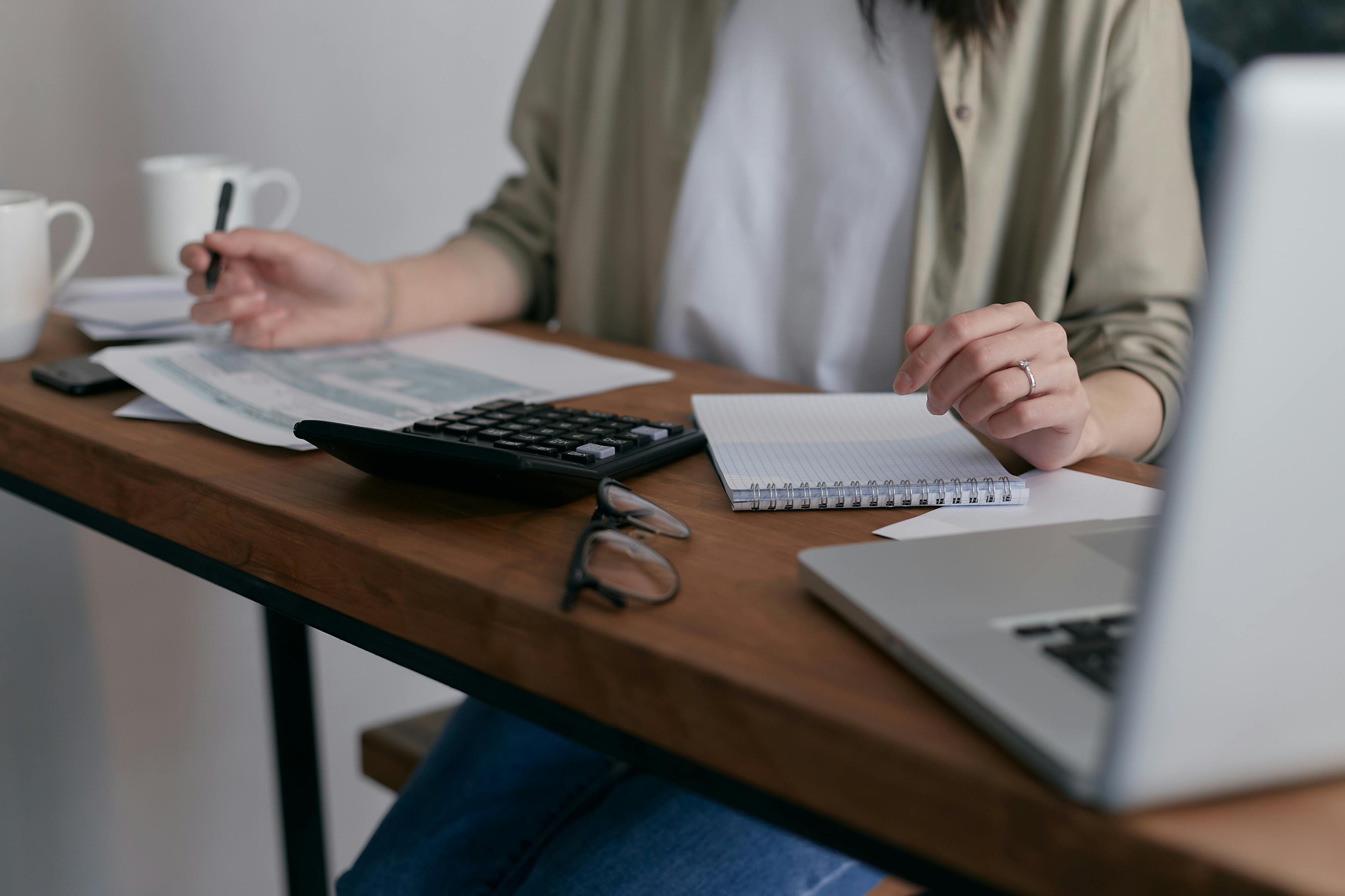 Real estate investor sits down and looks at numbers for acquiring an inherited property.
